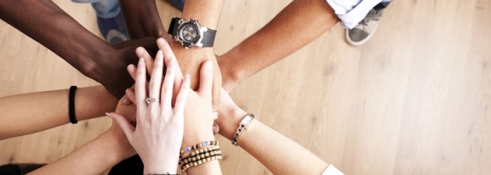 working_together_diverse_hands_coming_together